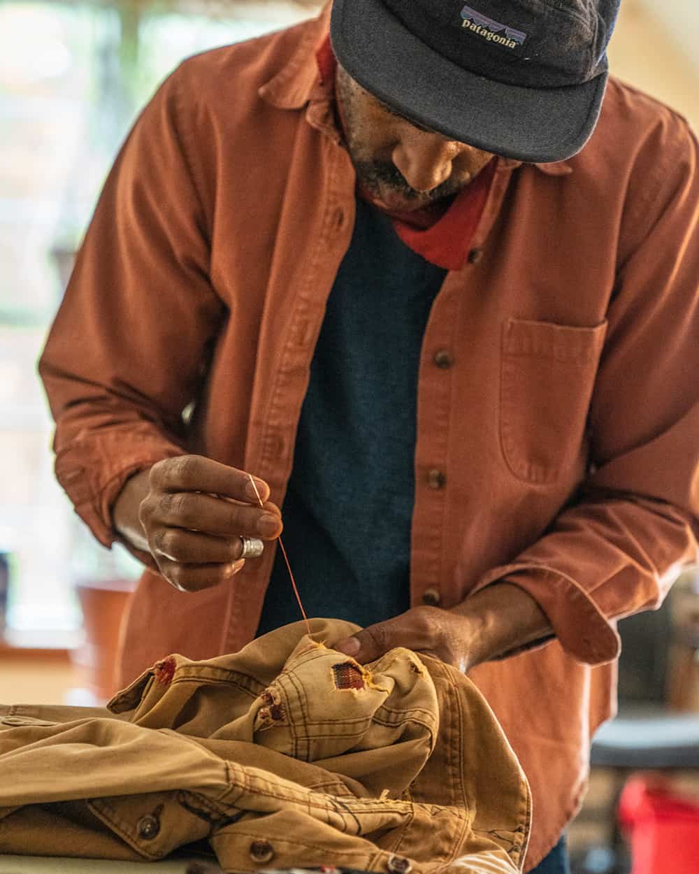 Man repairing a Patagonia men's garment