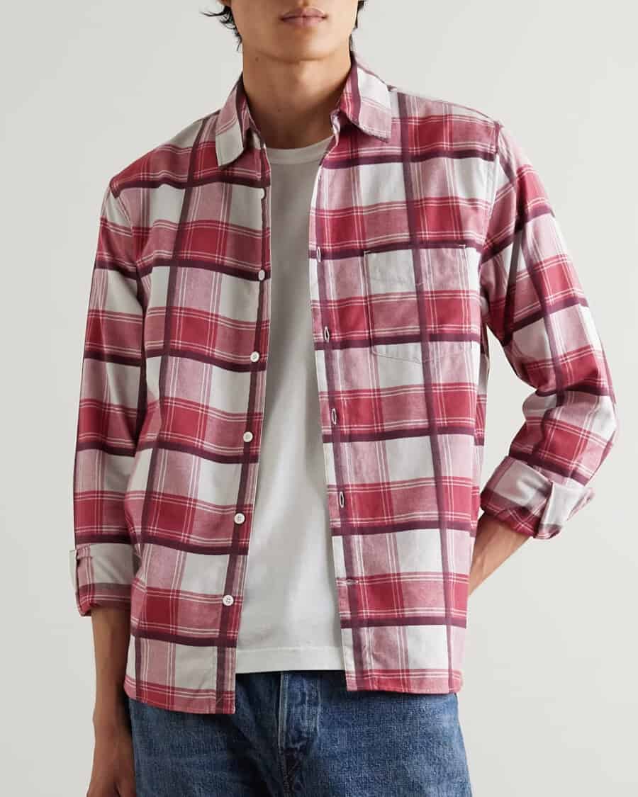 Man wearing Mr P red check flannel shirt over a white T-shirt with mid-wash blue jeans