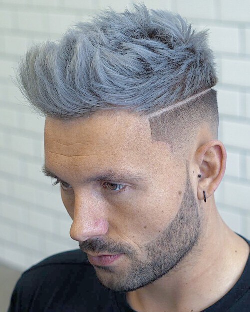 Men's mid-length faux hawk hairstyle with silver hair colour, low skin fade and hard parting line