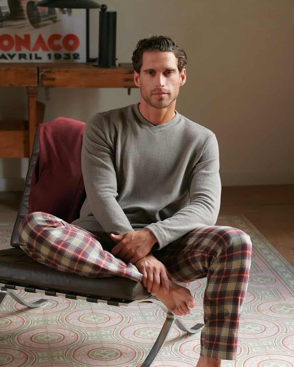 Man wearing Hanro grey lounge top and red tartan check pajama bottoms