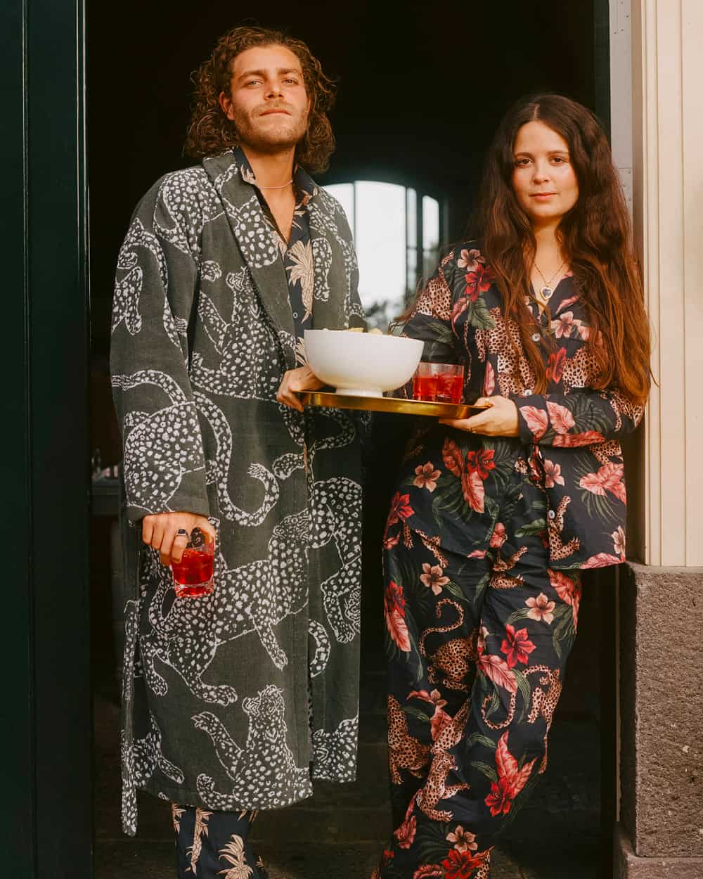 Man and woman wearing printed Desmond & Dempsey pajamas and robes