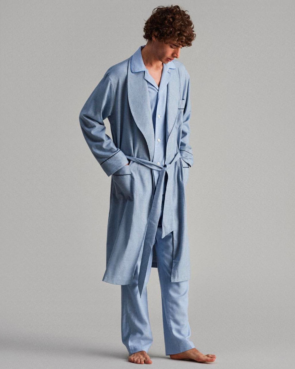 Man wearing luxury tailored sky blue pajamas and shawl collar robe by Thom Sweeney