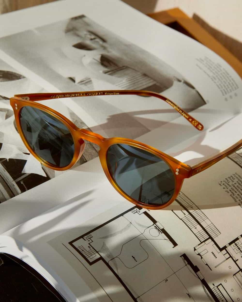 Pair of orange acetate frame and blue lens Oliver Peoples sunglasses for men