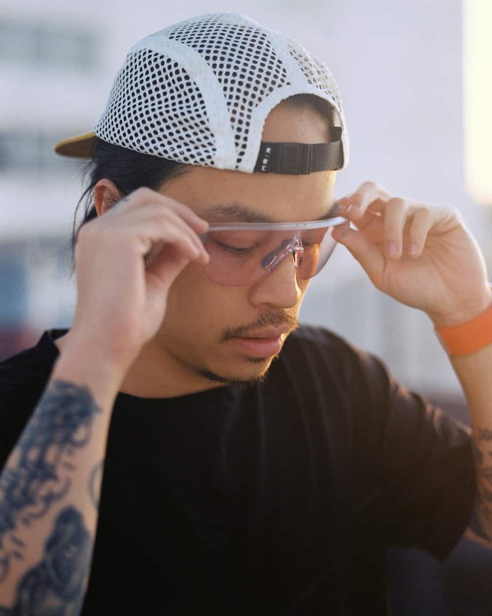 Man wearing clear Oakley wraparound sunglasses with baseball cap