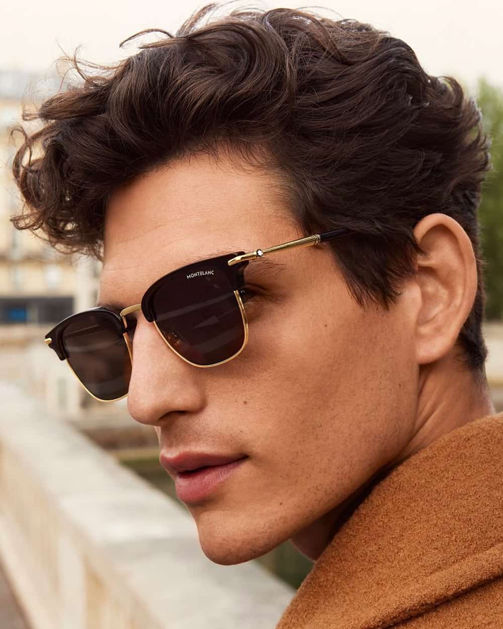 Man wearing Montblanc gold frame and black lens sunglasses