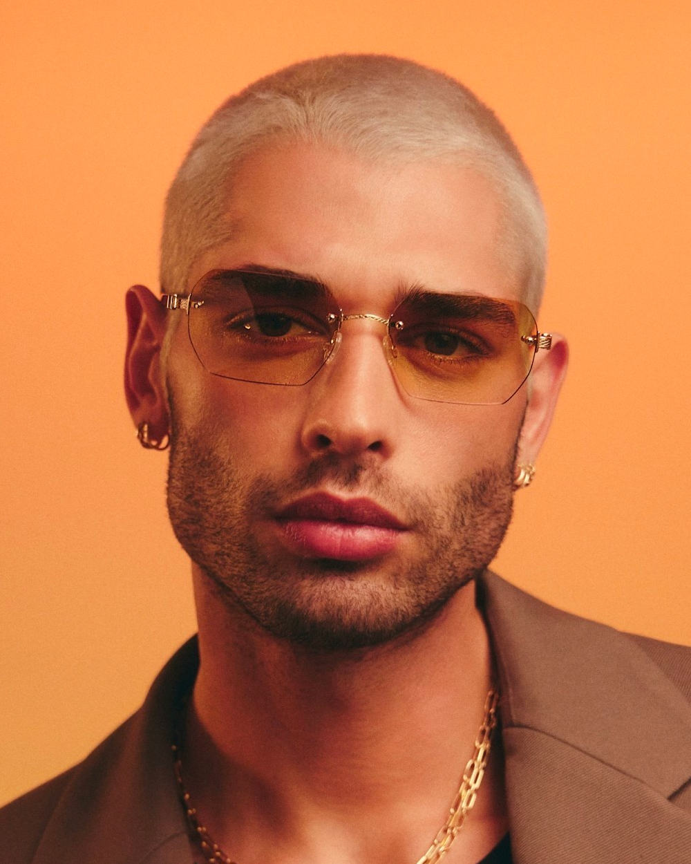 Man wearing Barton Perreira geometric sunglasses with yellow lenses