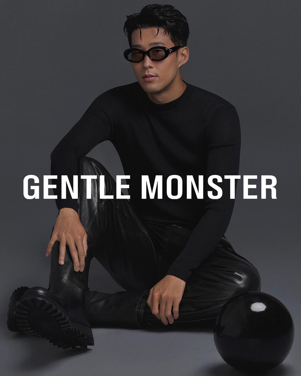 Korean man wearing Gentle Monster black frame oval sunglasses