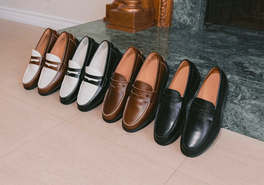 4 pairs of penny loafers by Duke and Dexter set against a marble fireplace