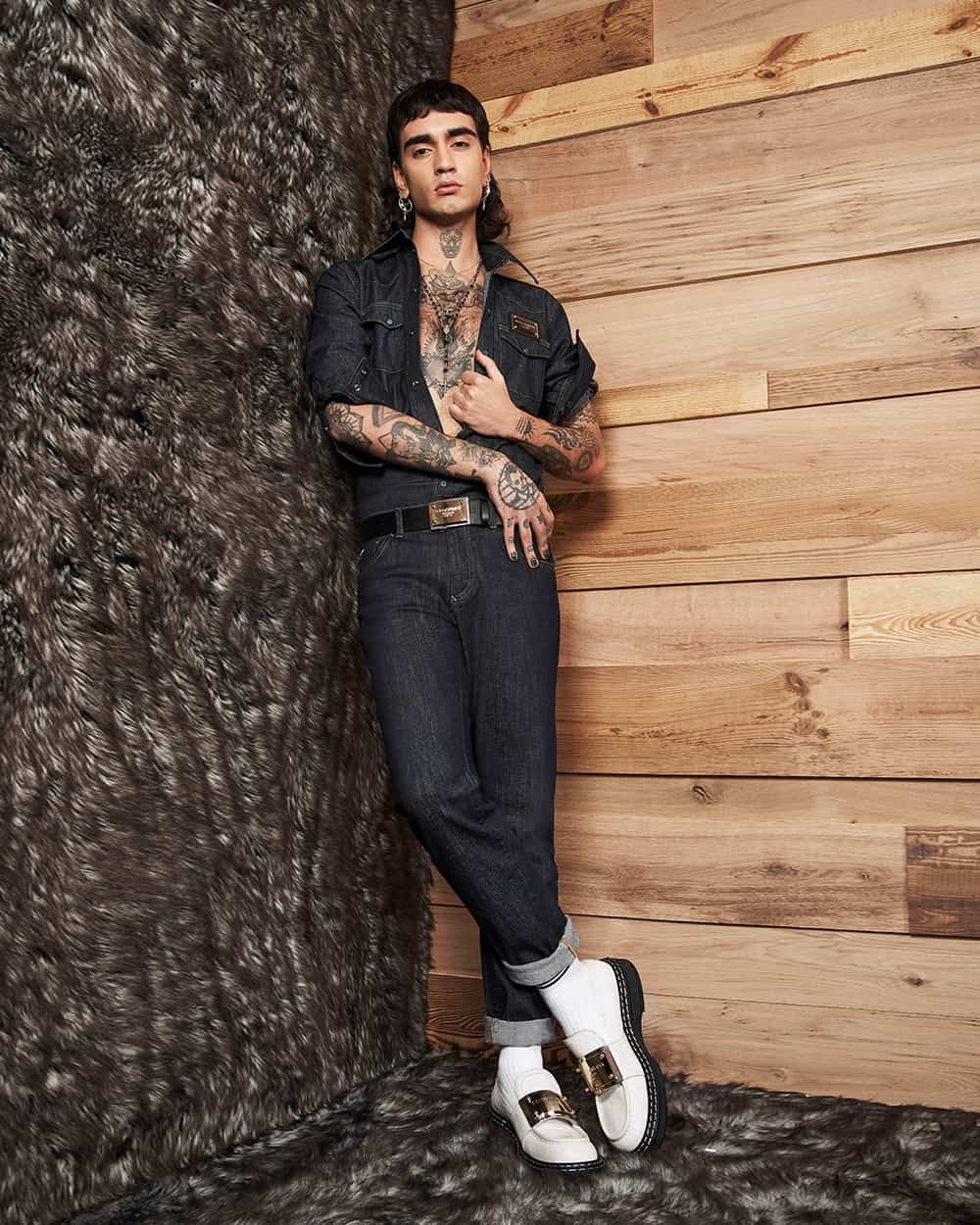 Man wearing double denim outfit with white socks and white Dolce and Gabbana loafers with metal plate