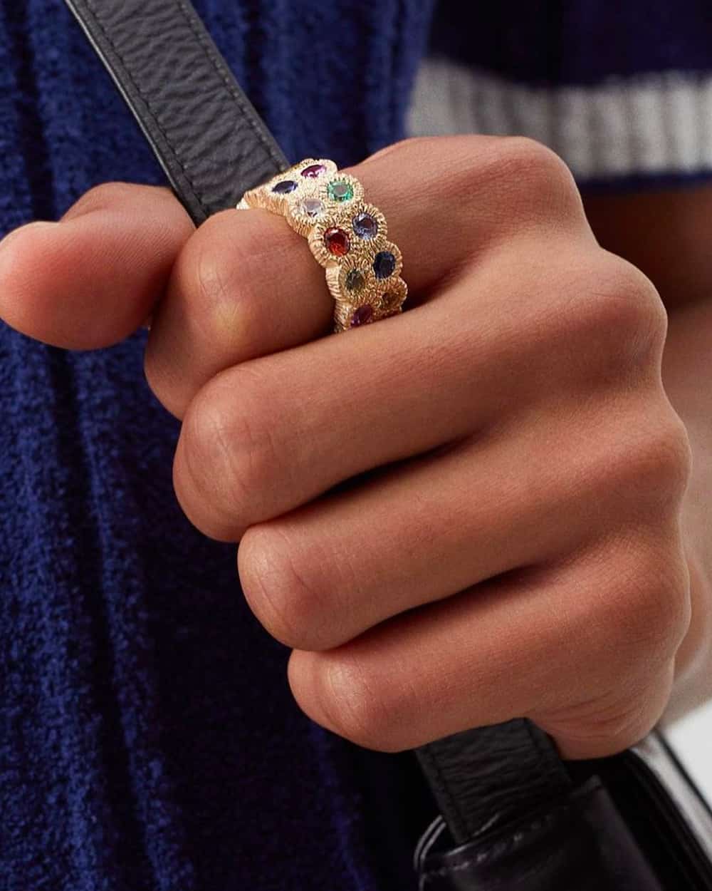 Close up of man wearing Bleue Burnham luxury gold signet ring with multicolored stones