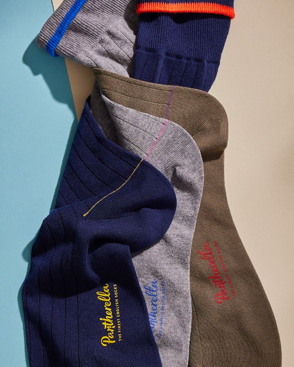 Three luxury men's Pantherella socks in navy, grey and olive green