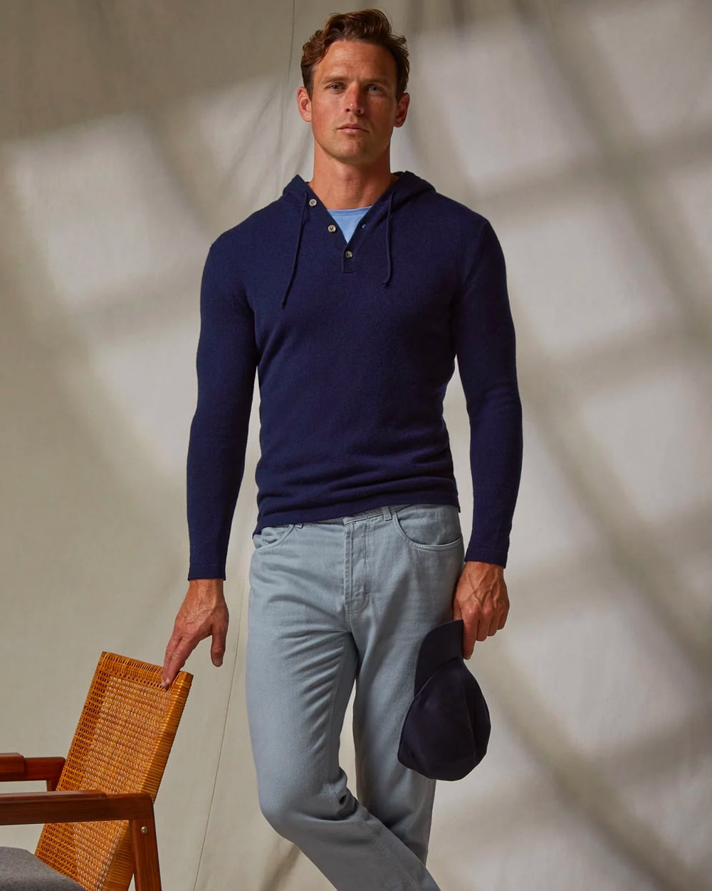 Man wearing a luxury cashmere navy hoodie by Luca Faloni with grey chinos and a light blue T-shirt