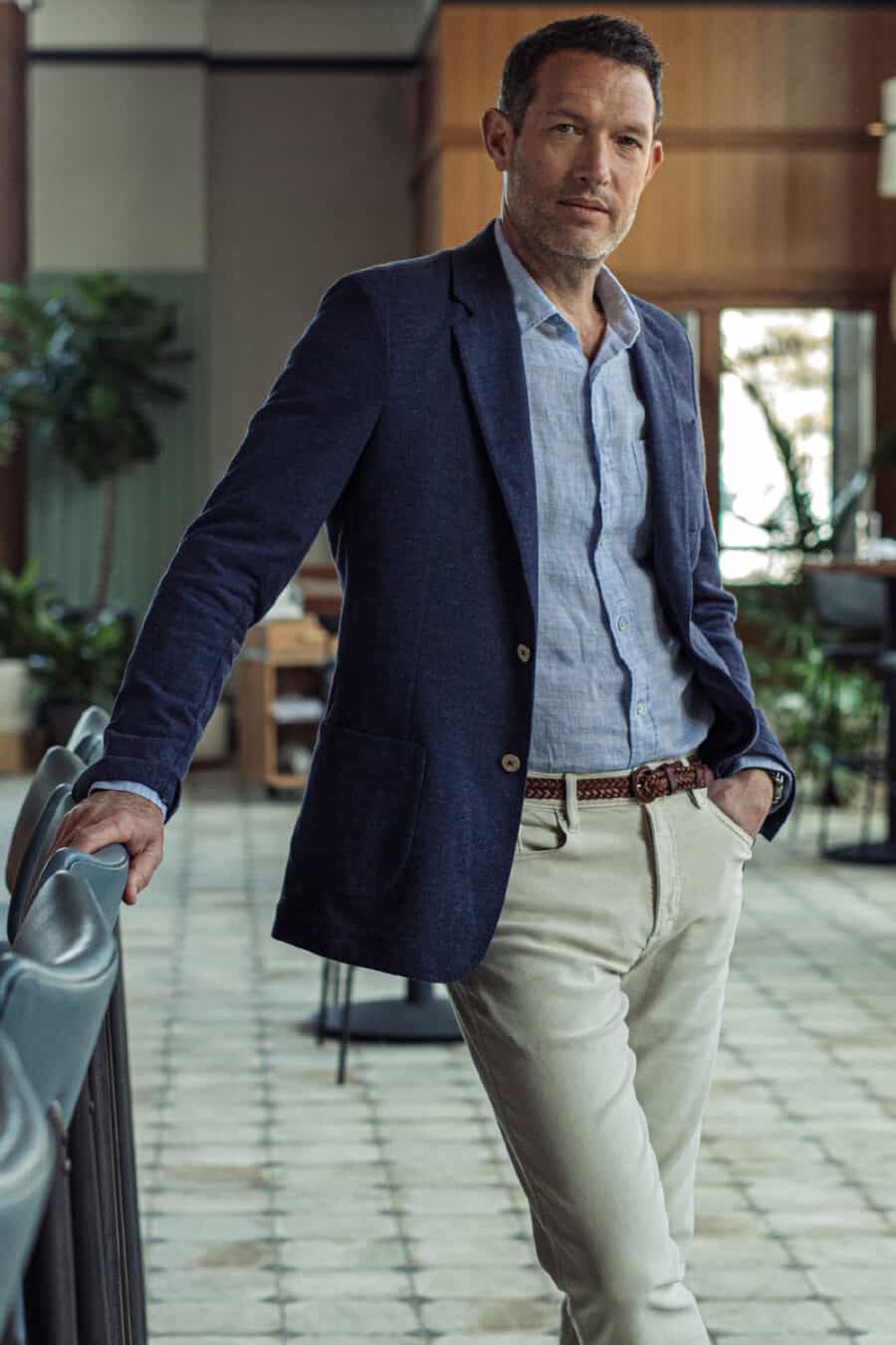 Men's light grey jeans, blue chambray shirt and navy blazer outfit