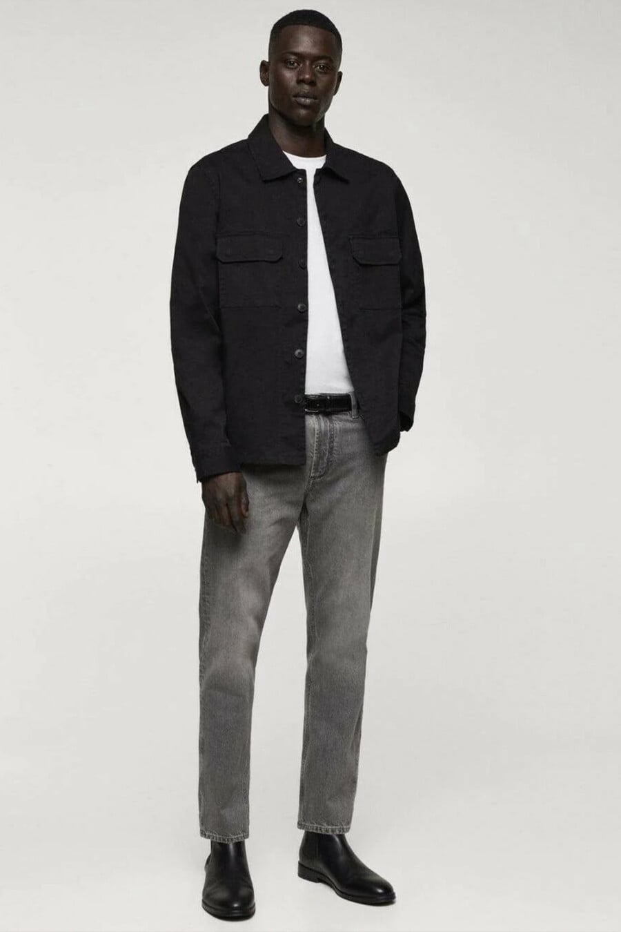 Men's dark grey jeans, white T-shirt, black overshirt and black leather Chelsea boots outfit