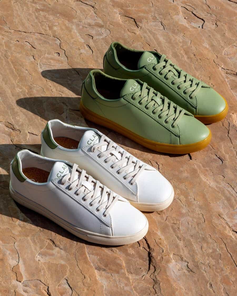 Two pairs of Clae vegan leather sneakers in all white and green with a gumsole