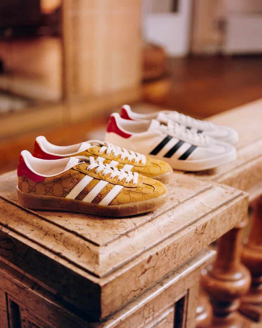 A pair of Adidas x Gucci all-over logo upper Samba men's sneakers in gold and red