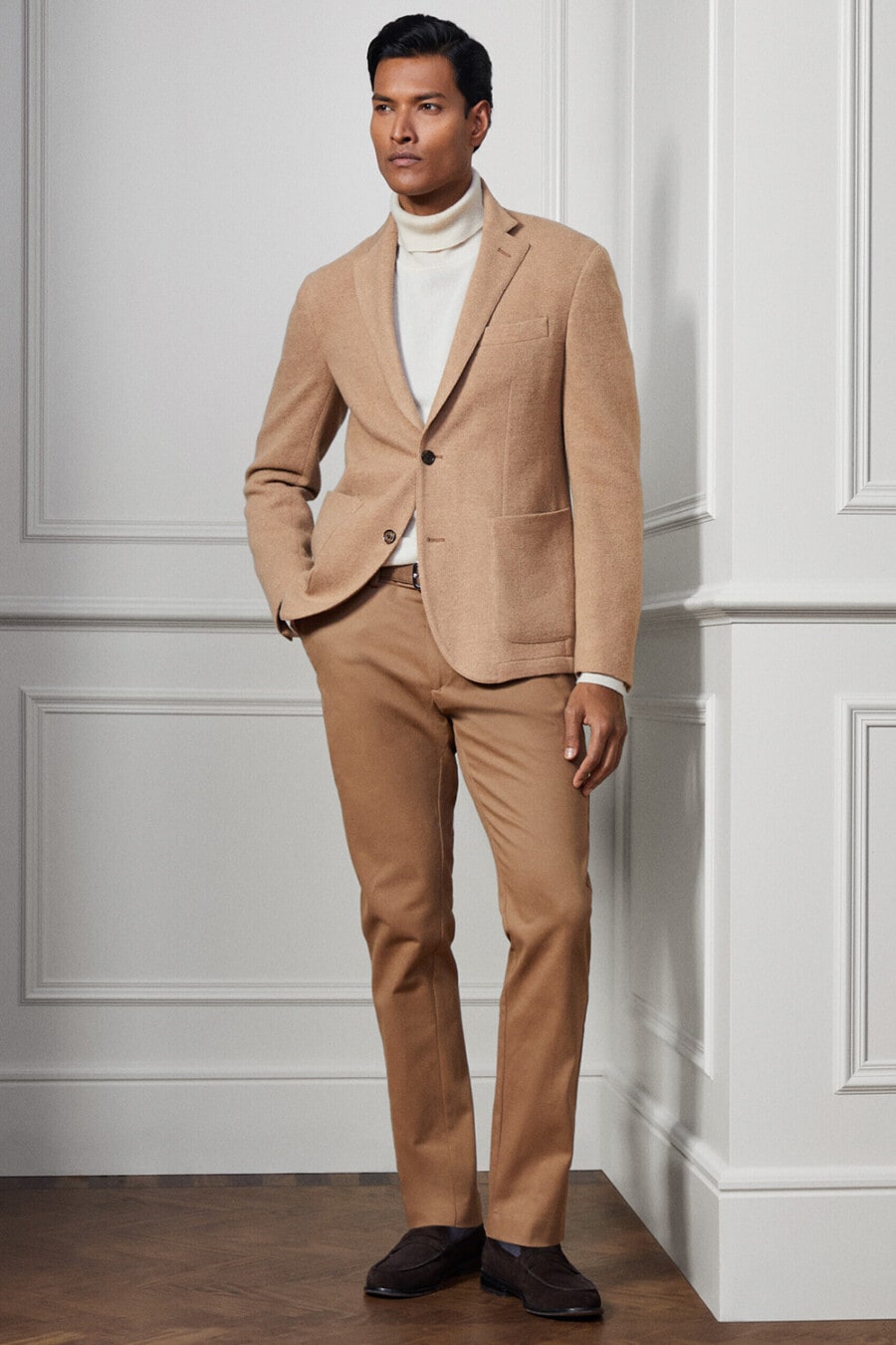 Men's khaki chinos, white turtleneck, camel blazer and brown suede penny loafers outfit