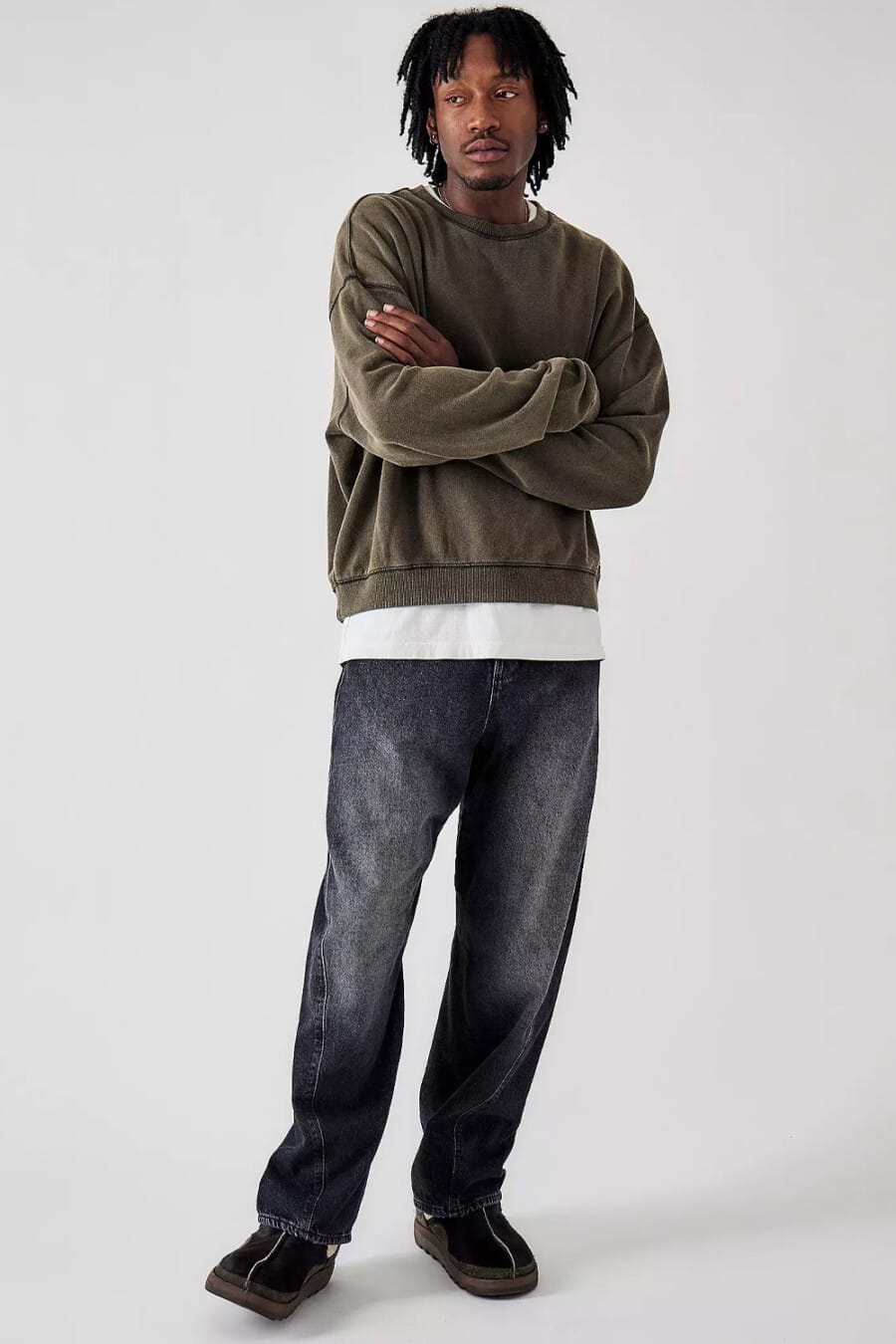 Men's faded black baggy jeans, longline white T-shirt, washed moss green sweatshirt and brown suede moccasins grunge outfit