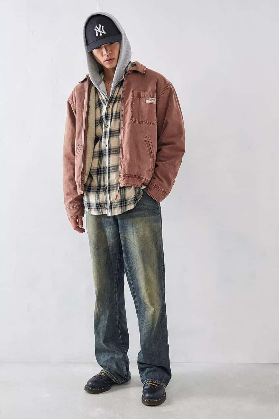 Men's baggy faded jeans, off-white/black check shirt, grey hoodie, red washed out jacket and chunky Dr. Martens boots grunge outfit