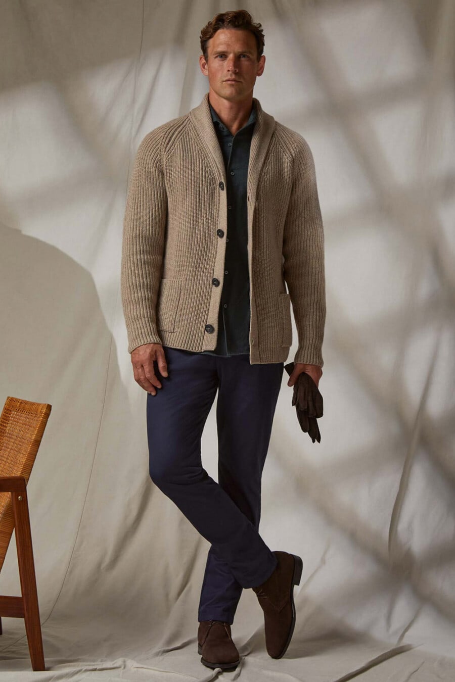 Men's navy pants, dark green shirt, biscuit chunky ribbed shawl neck cardigan and brown suede boots outfit