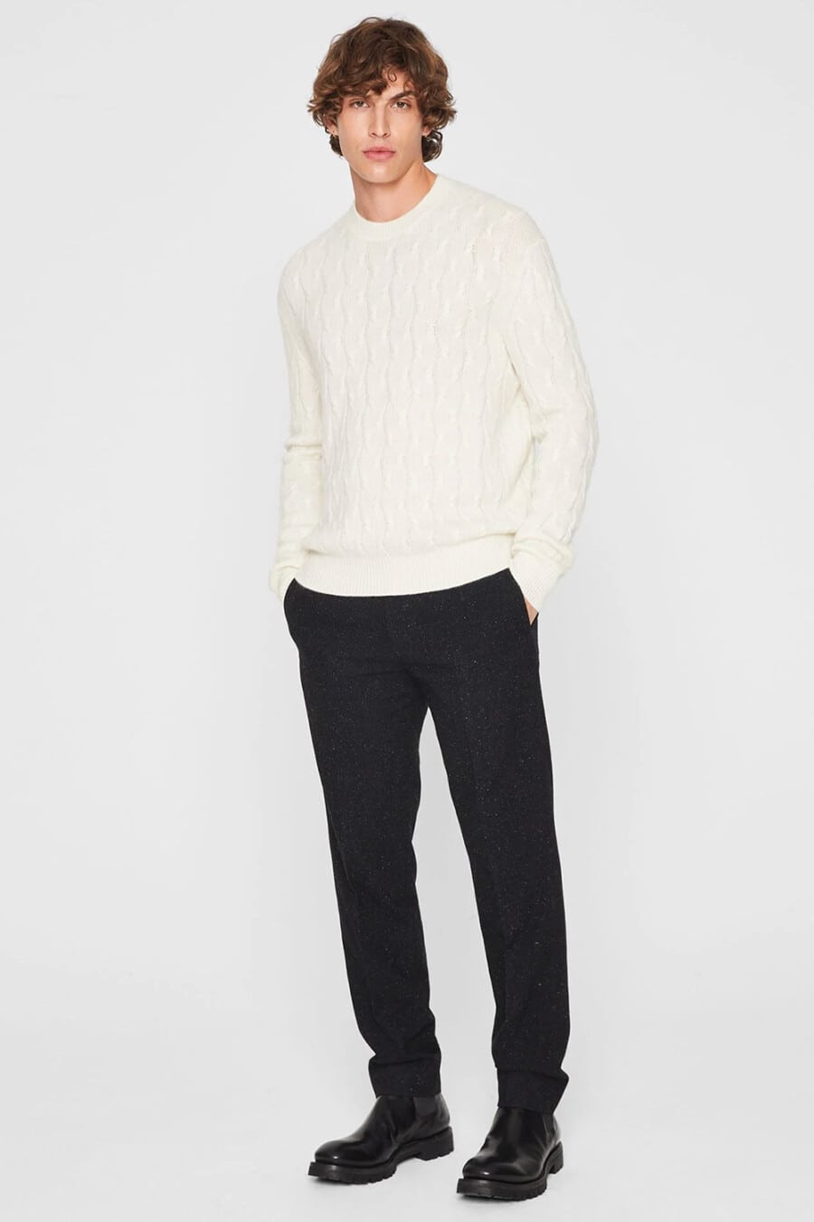 Men's black wool pants, white cable knit sweater and black leather Chelsea boots outfit