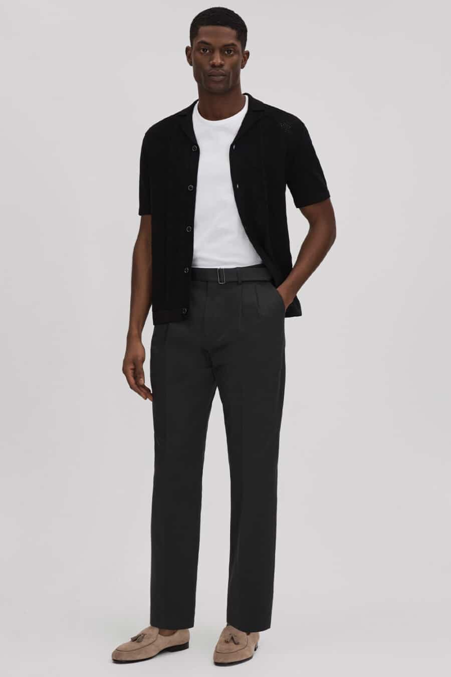 Men's black tailored pants, white T-shirt, black open knit shirt and taupe suede tassel loafers outfit