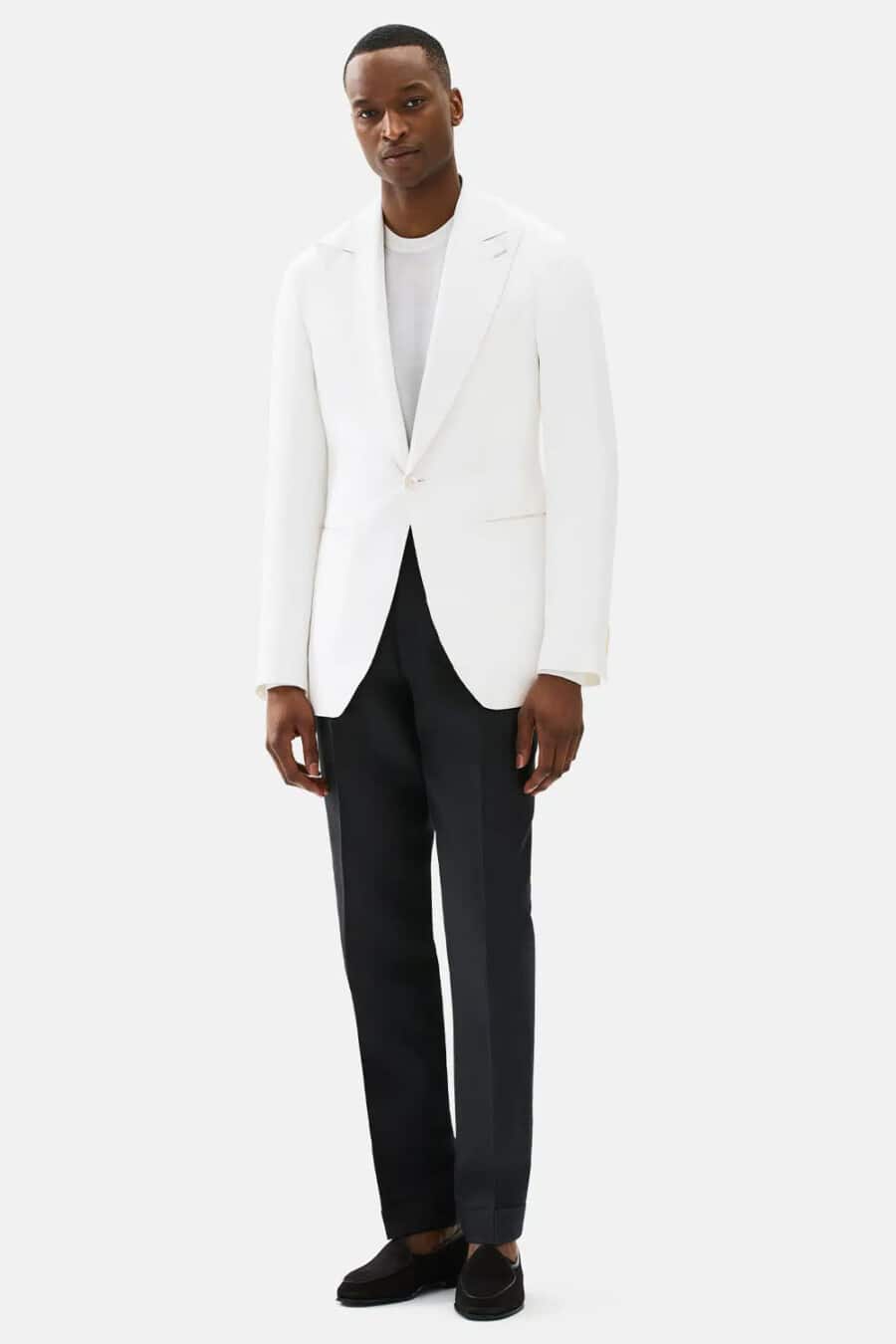 Men's black dress pants, white long-sleeve top, white tuxedo jacket and black suede slippers outfit