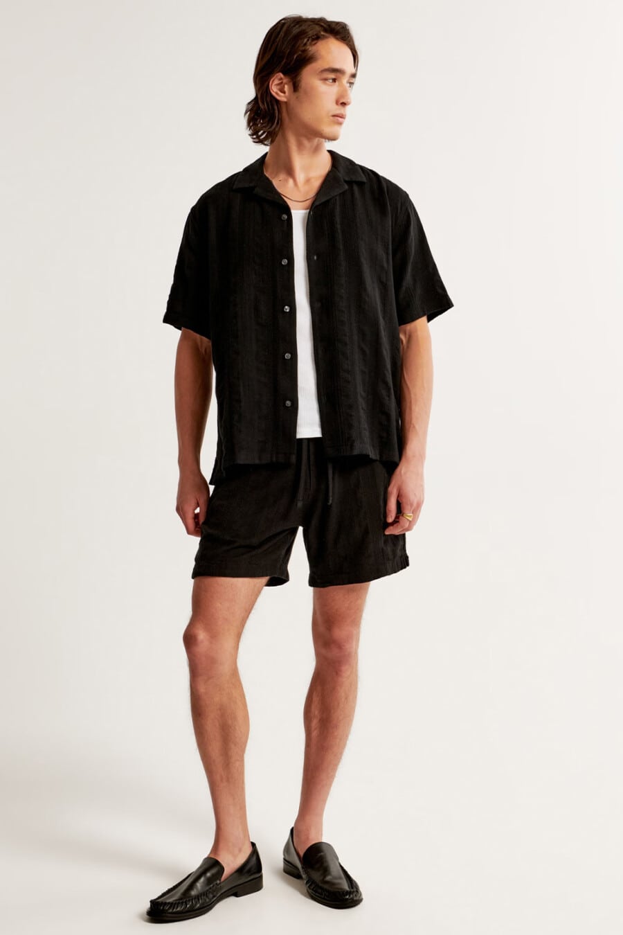 Men's black shorts, black short-sleeve shirt, white T-shirt and black leather loafers outfit