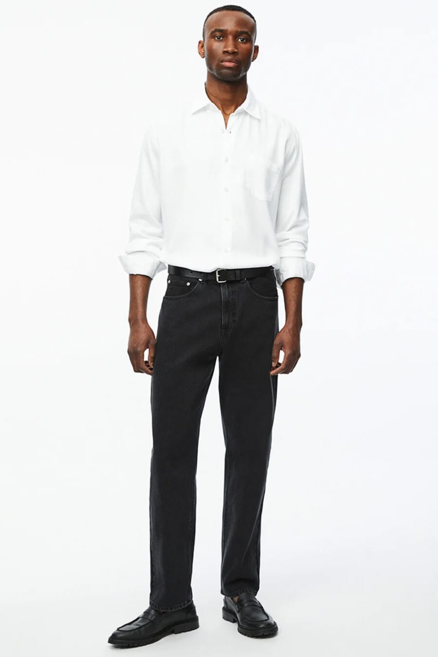 Men's white shirt tucked into black jeans with black leather belt and black leather penny loafers outfit 