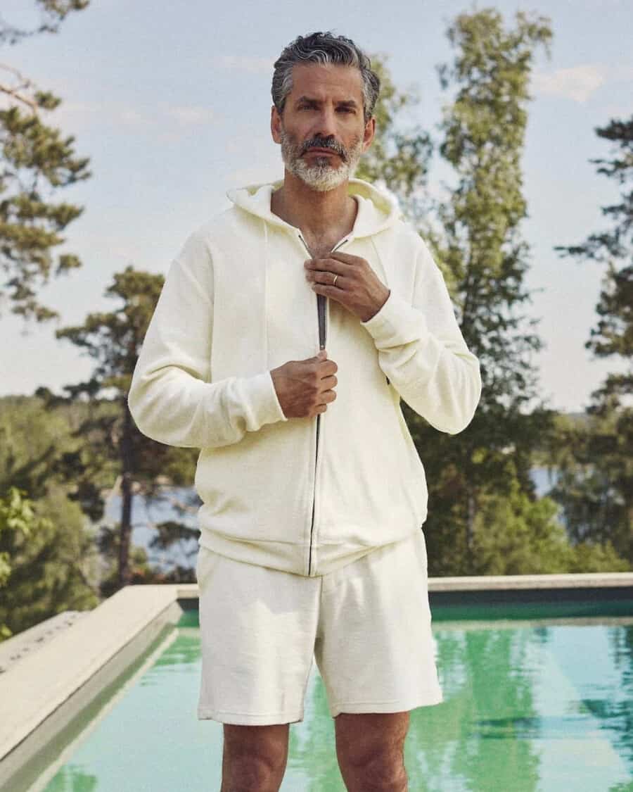 Man wearing a matching terry toweling hoodie and short set by The Resort Co.
