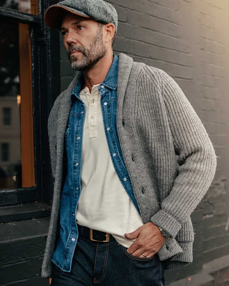 Men's T-shirt trend - man wearing a Henely shirt with a denim shirt, shawl collar cardigan and raw denim jeans