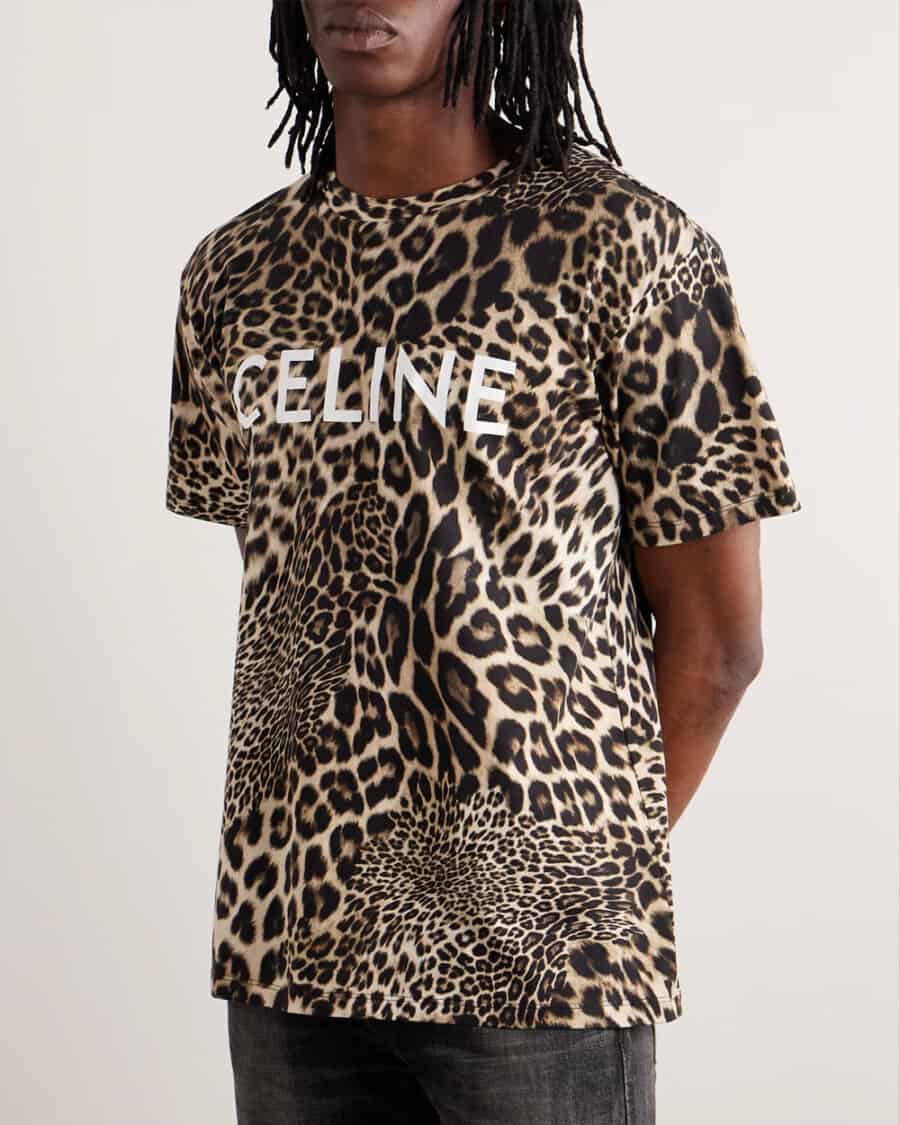 Men's T-shirt trends - man wearing an all-over leopard animal print T-shirt by Celine with black jeans